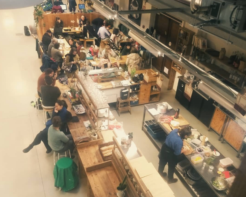 Top view of the busy open kitchen and the tables around it