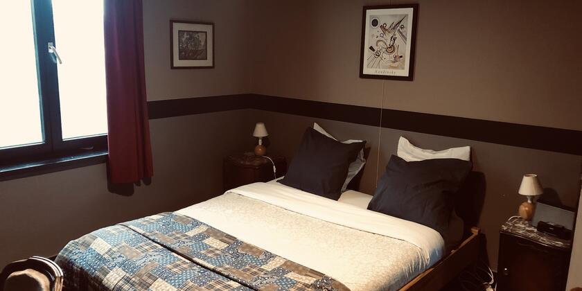 A made-up double bed in one of the characterful rooms