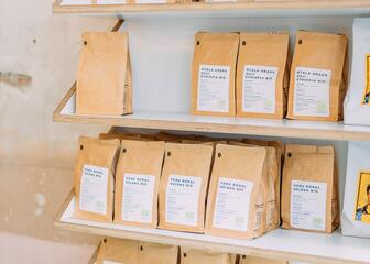 shelves with various brown bags filled with coffee beans